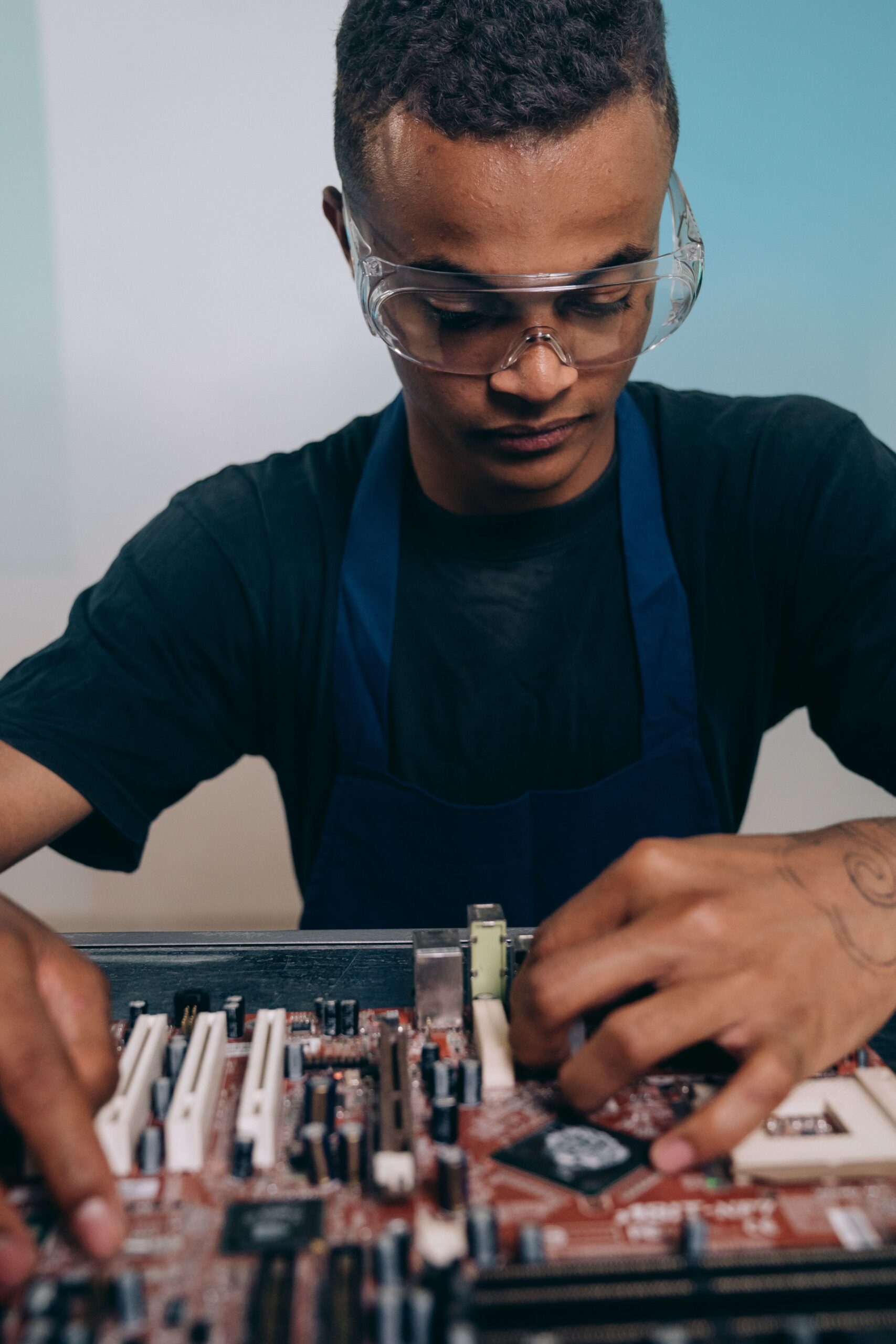 Focused IT network support technician repairing a business computer.